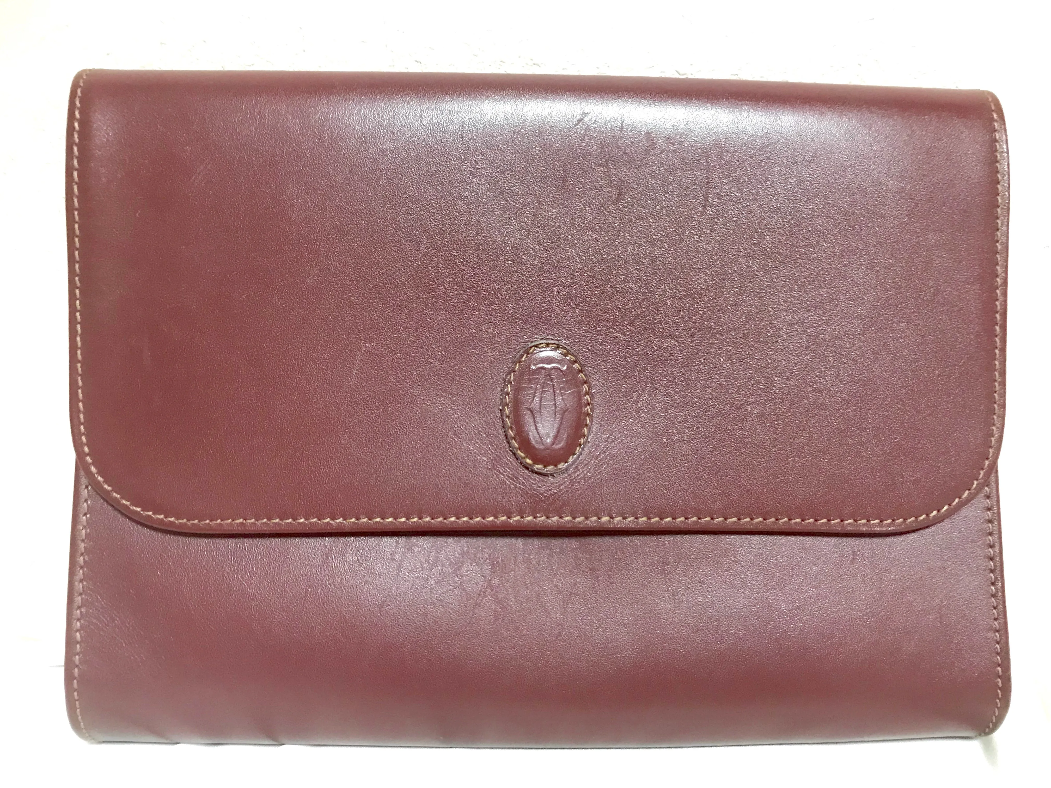 Vintage Cartier wine leather clutch bag, mini document purse with logo motif. Unisex bag from must de Cartier Collection. 060531r8